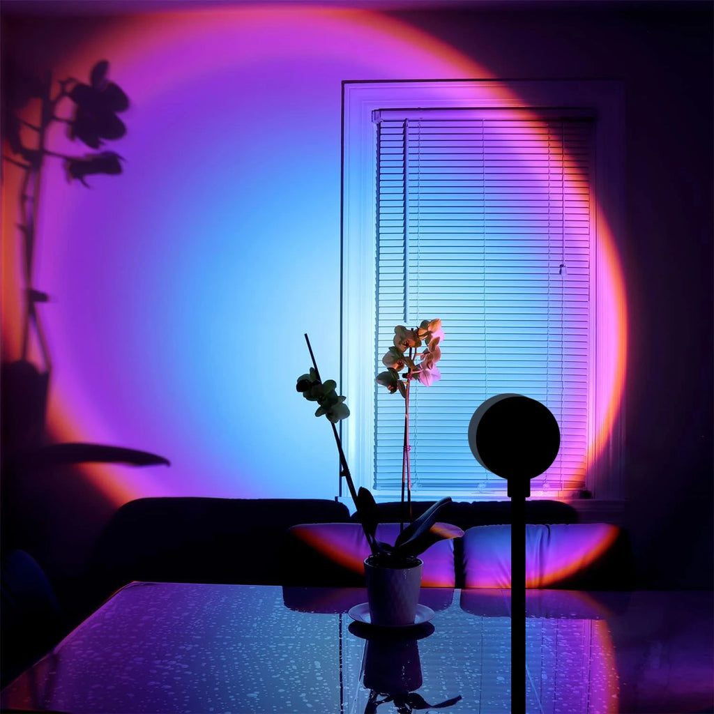 Sunset projection lamp casting blue-purple gradient on wall